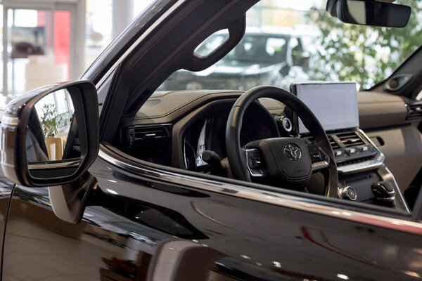 Россия, Ижевск - 30 сентября 2021 года: выставочный зал Toyota. Интерьер нового современного Land Cruiser 300 в салоне дилера. Современный транспорт. Известный мировой бренд.