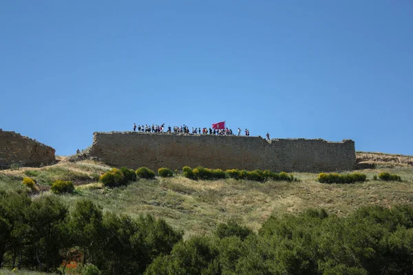 Güneşli Bir Bahar Gününde Kırmızı Bayrakla Duvarların Tepesindeki Insanlar — Stok fotoğraf