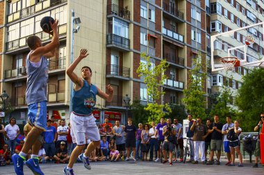Valladolid, Spain; june 27 2013: Basketball long shot well defended at the King of the Rock basketball tournament