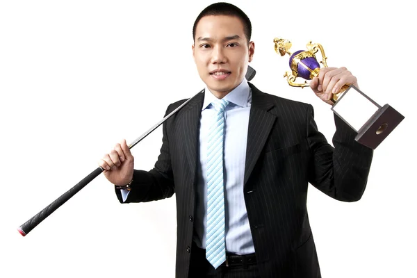 Businessman holding the trophy with golf club — Stock Photo, Image