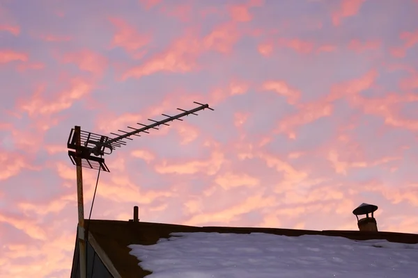 TV antenna against reddish cloudy sky — Stock Photo, Image