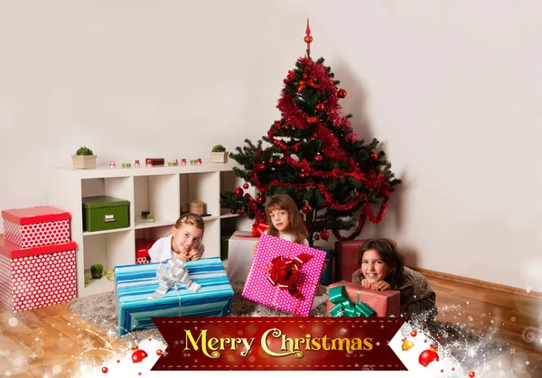 Kids with their christmas presents — Stock Photo, Image