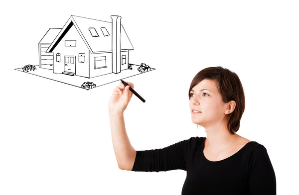 Young woman drawing a house on whiteboard — Stock Photo, Image