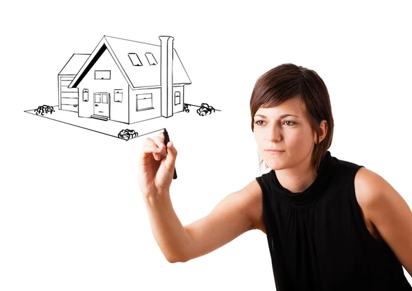 Young woman drawing a house on whiteboard — Stock Photo, Image