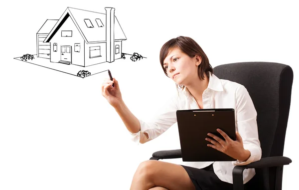 Young woman drawing a house on whiteboard — Stock Photo, Image