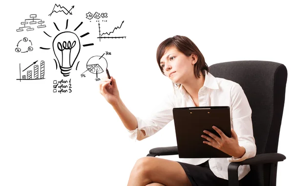 Young business woman drawing light bulb with various diagrams an — Stock Photo, Image