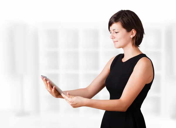 Young woman looking at modern tablet — Stock Photo, Image