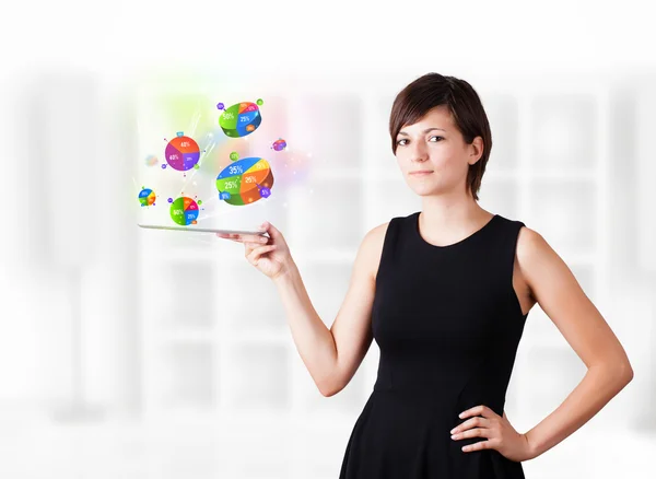 Young woman looking at modern tablet with pie charts — Stock Photo, Image