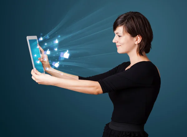 Young woman looking at modern tablet with abstract lights and so — Stock Photo, Image