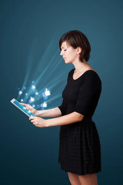 Young woman looking at modern tablet with abstract lights and so — Stock Photo, Image