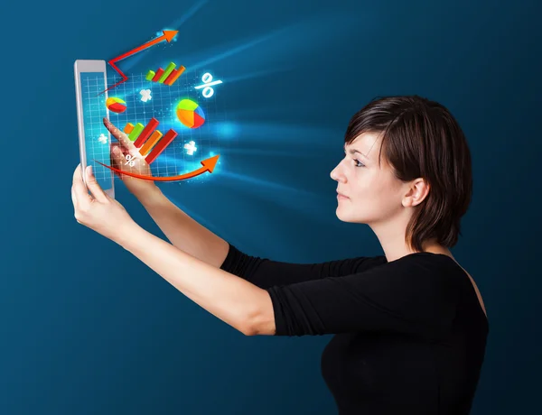 Young woman looking at modern tablet with abstract lights and va — Stock Photo, Image