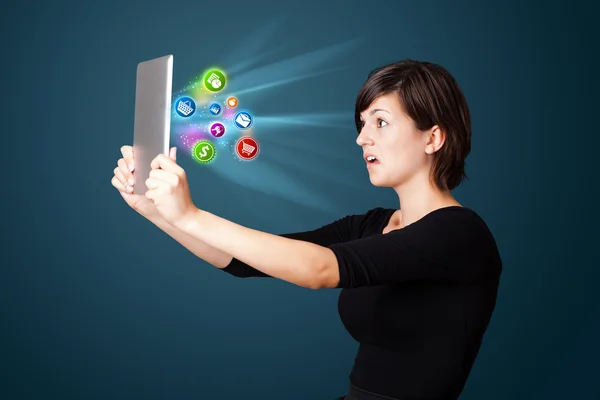 Young woman looking at modern tablet with abstract lights and va — Stock Photo, Image