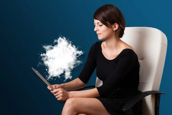 Young woman looking at modern tablet with abstract cloud — Stock Photo, Image