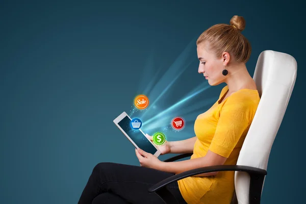 Young woman looking at modern tablet with abstract lights and va — Stock Photo, Image