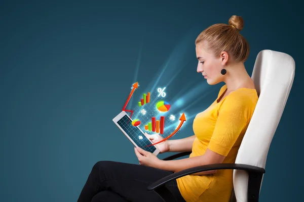 Young woman looking at modern tablet with abstract lights and va — Stock Photo, Image