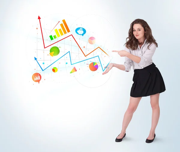 Young business woman presenting colorful charts and diagrams — Stock Photo, Image