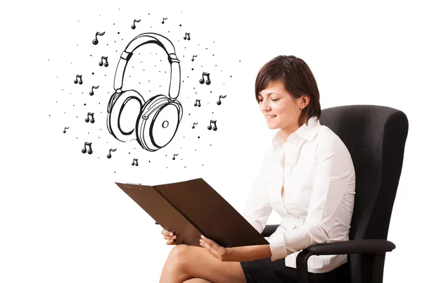 Young girl presenting headphone and musical notes — Stock Photo, Image