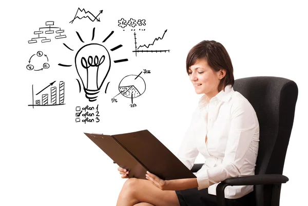 Young business woman presenting light bulb with various diagrams — Stock Photo, Image