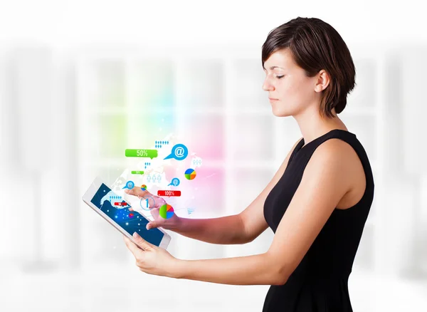 Young woman looking at modern tablet with colourful technology i — Stock Photo, Image