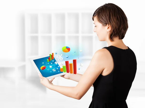 Young woman looking at modern tablet with colourful diagrams — Stock Photo, Image