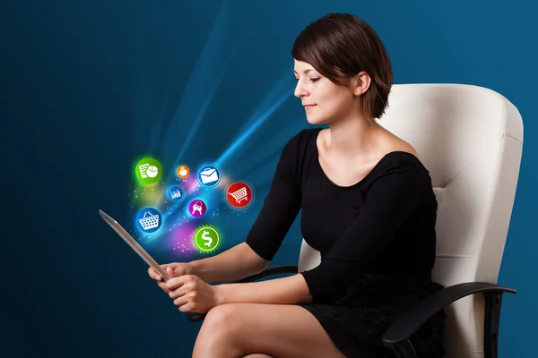 Young woman looking at modern tablet with abstract lights and va — Stock Photo, Image