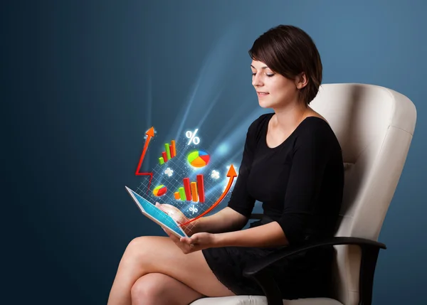 Young woman looking at modern tablet with abstract lights and va — Stock Photo, Image