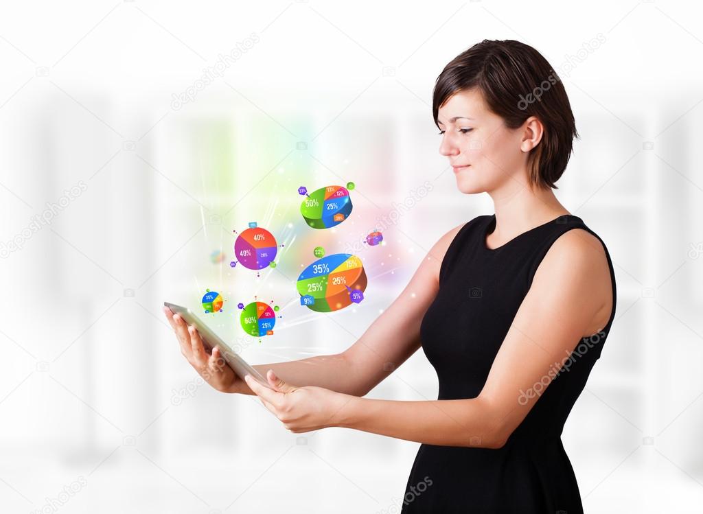 Young woman looking at modern tablet with pie charts