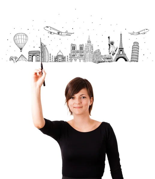 Young woman drawing famous cities and landmarks on whiteboard — Stock Photo, Image
