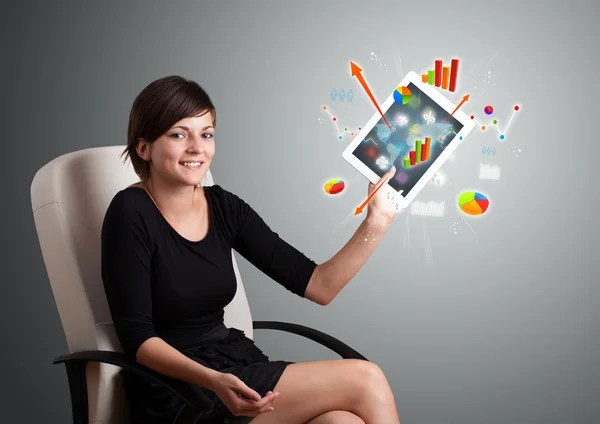 Woman holding modern tablet with colorful diagrams and graphs — Stock Photo, Image