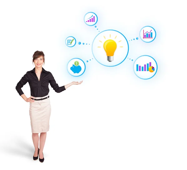 Young woman presenting light bulb with colorful graphs and diagr — Stock Photo, Image