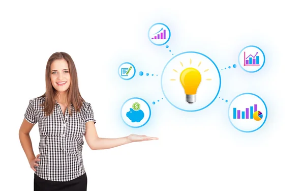 Young woman presenting light bulb with colorful graphs and diagr — Stock Photo, Image