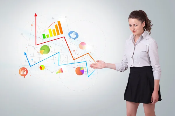 Young business woman presenting colorful charts and diagrams — Stock Photo, Image