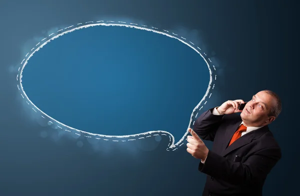 Funny businessman holding a phone and presenting speech bubble c — Stock Photo, Image