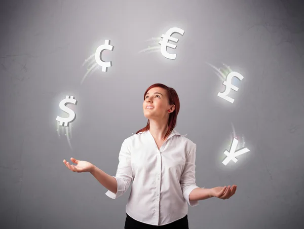 Young lady standing and juggling with currency icons — Stock Photo, Image