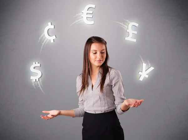 Young lady standing and juggling with currency icons — Stock Photo, Image