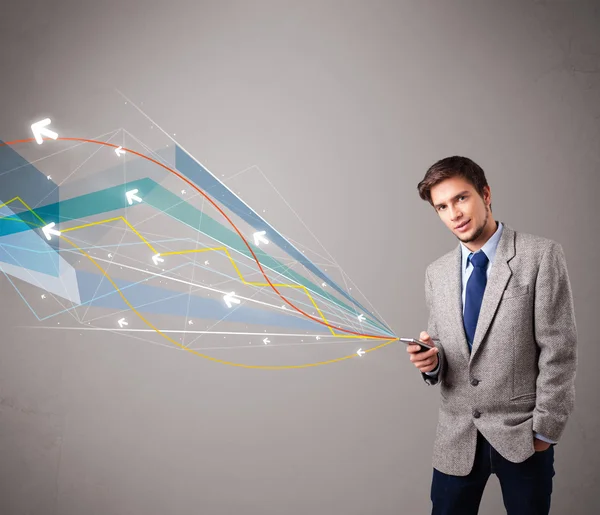 Joven guapo sosteniendo un teléfono con flechas abstractas coloridas — Foto de Stock