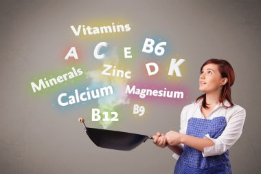 Genç bir kadın vitamin ve mineral pişiriyor.