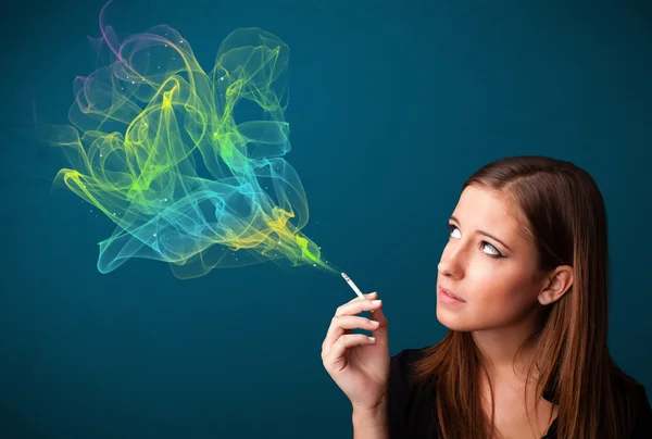 Pretty lady smoking cigarette with colorful smoke — Stock Photo, Image