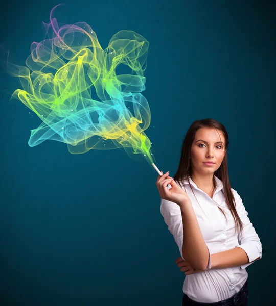 Pretty lady smoking cigarette with colorful smoke — Stock Photo, Image
