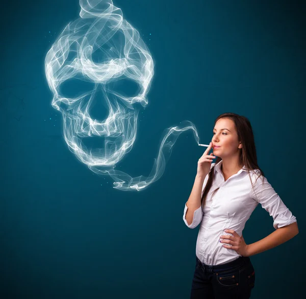 Young woman smoking dangerous cigarette with toxic skull smoke — Stock Photo, Image
