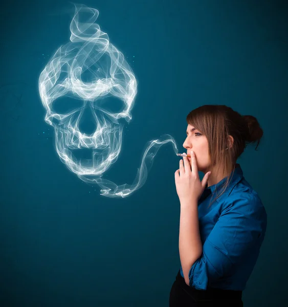 Young woman smoking dangerous cigarette with toxic skull smoke — Stock Photo, Image