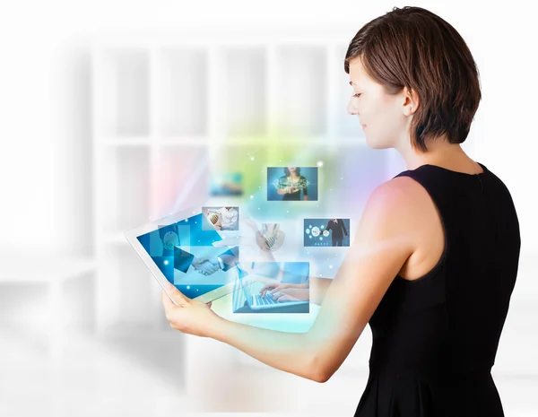 Young woman browsing pictures on modern tablet — Stock Photo, Image