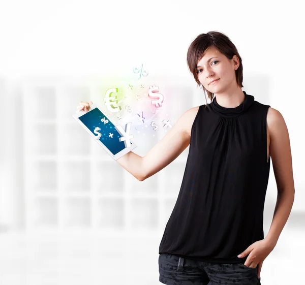 Young woman looking at modern tablet with currency icons — Stock Photo, Image