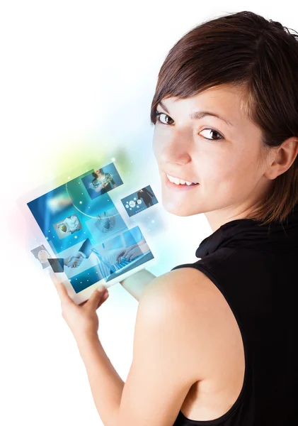 Young woman browsing pictures on modern tablet — Stock Photo, Image