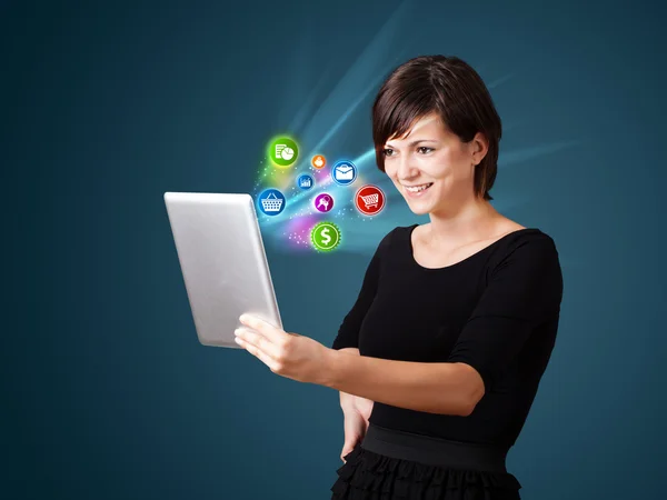 Young woman looking at modern tablet with abstract lights and va — Stock Photo, Image