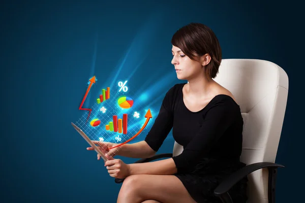 Young woman looking at modern tablet with abstract lights and va — Stock Photo, Image