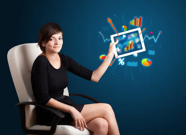 Woman holding modern tablet with colorful diagrams and graphs — Stock Photo, Image