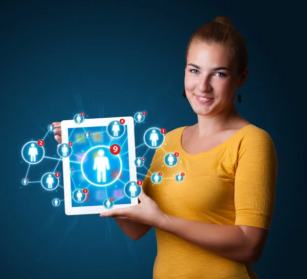 Young woman holding tablet with social network icons — Stock Photo, Image