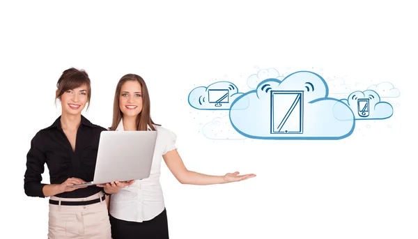 Beutiful young women presenting modern devices in clouds — Stock Photo, Image