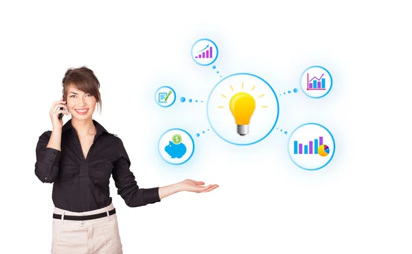 Young woman presenting light bulb with colorful graphs and diagr — Stock Photo, Image